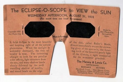 A boxy light brown-coloured mask with black eye holes. The mask is covered in text describing solar eclipses and using this form of eye protection. The text at the top of the mask reads: 'The ECLIPSE-O-SCOPE to VIEW the SUN'.