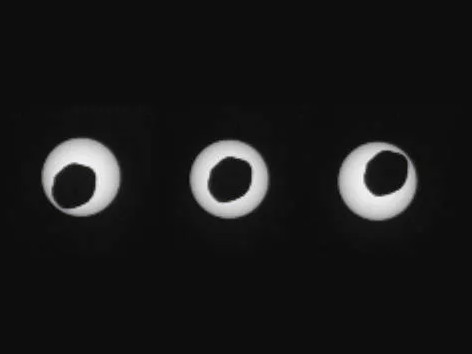 Mars' largest Moon partially obscuring the Sun, causing a solar eclipse. The Moon is much smaller than Earth's and isn't spherical, so it doesn't fully obscure the Sun.